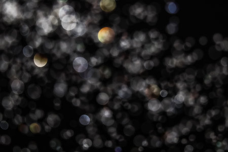 white bokeh and black background from water drop