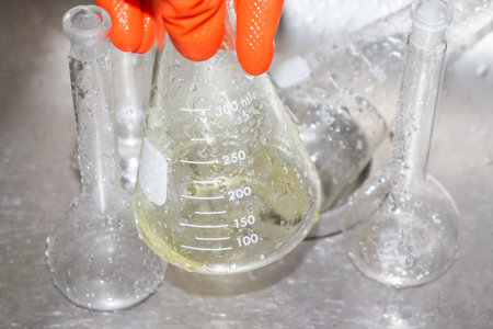 Clean the chemical glass in laboratory with glove