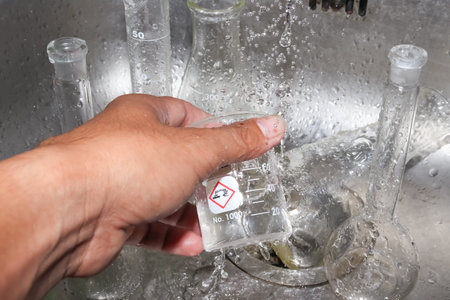 Clean the chemical glass in laboratory with bare hand