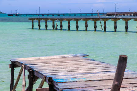 wooden bridge by the sea in the morningの写真素材