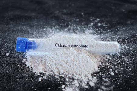 Calcium carbonate in test tube and black backgroundの写真素材