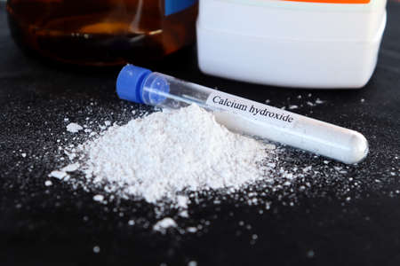 Calcium hydroxide in test tube and black backgroundの写真素材