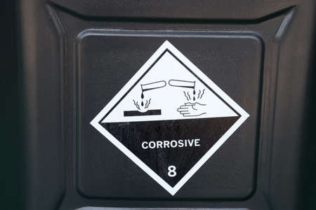 Corrosive chemical symbols on a black chemical tankの写真素材
