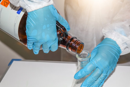 Pour chemicals into glass bottle, chemical in laboratory or industryの写真素材