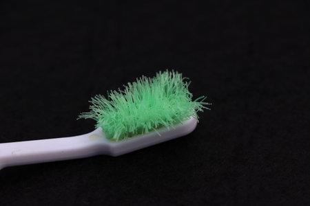 old dirty toothbrush and hard on black backgroundの写真素材