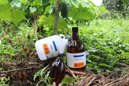 Chemical bottles from the industry or laboratory and destroy natureの写真素材