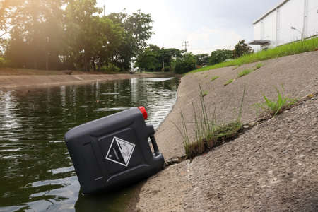 black chemical tank in industrial canal and destroy the environmentの写真素材