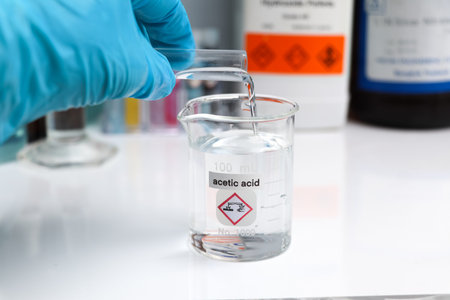 Acetic acid in glass, chemical in the laboratory and industry