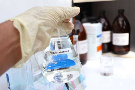 Dichloromethane in glass, chemical in the laboratory and industryの写真素材