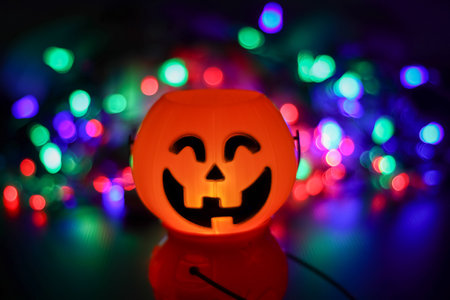 Halloween pumpkin smile and scary eyes for party night, bokeh background from lights at nightの写真素材