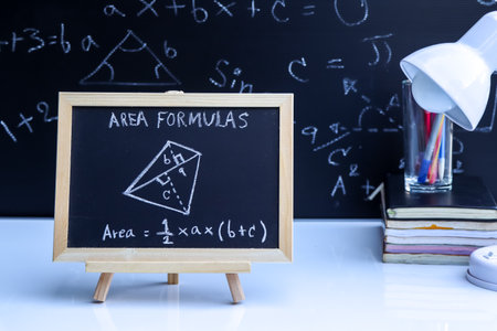 Blackboard with hand written geometry area formulas and geometric shapes and figuresの写真素材