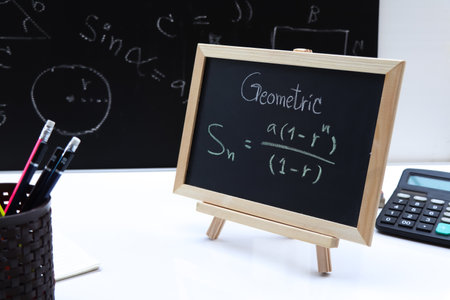 Blackboard with hand written Sequences and Series Formulas and geometric shapes and figuresの写真素材
