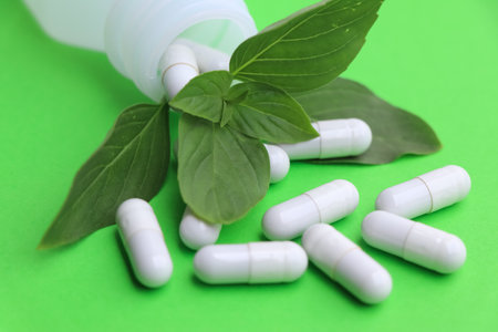 herbal pills or vitamins and green leaf, bio supplement, eco friendlyの写真素材