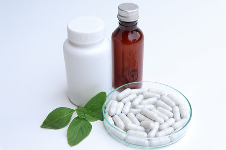 herbal pills or vitamins and green leaf, bio supplement, eco friendlyの写真素材