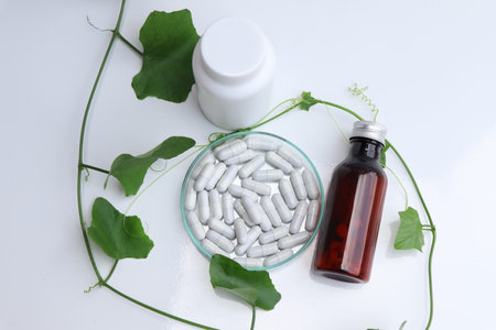 herbal pills or vitamins and green leaf, bio supplement, eco friendlyの写真素材