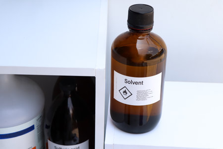 Solvent in glass,Hazardous chemicals and symbols on containers in factory or laboratoryの写真素材