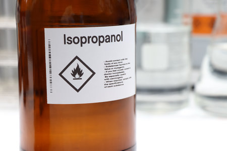 Isopropanol in glass, Hazardous chemicals and symbols on containers in industry or laboratoryの写真素材