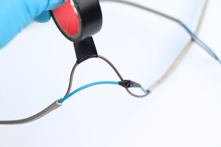 An electrician connects electrical wires using electrical leakage tape, Maintenance and knowledge