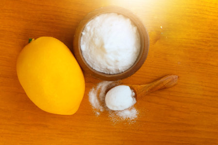 Citric acid white powder, Lemon extract is used as raw material, wood backgroundの写真素材