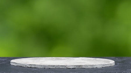 Empty white marble podium on green bokeh background. For product displayの写真素材