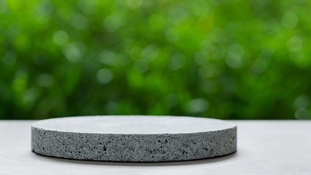 Empty concrete podium for product display and green bokeh nature backgroundの写真素材
