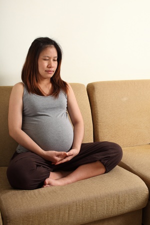 Pregnant Asian Woman Meditating. Warm tone color.の写真素材