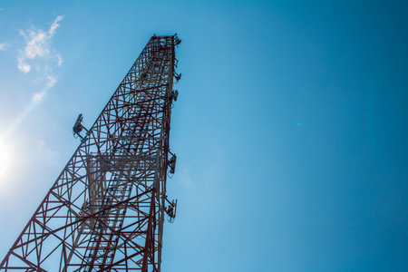 Communications tower with blue Cloud sky backgroundCommunications tower with blue Cloud sky backgroundの写真素材