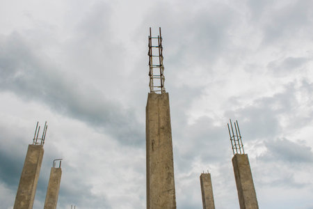 Concrete poles in construction site ,cement pillar with blue Cloud sky backgroundの写真素材