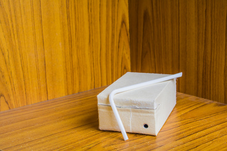 Brown milk carton is crumple On Wood backgroundの写真素材