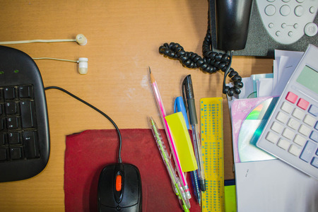 Office desk with office equipment,Keyboard and mouse, calculator, Earphone,phone and CD disk.Pencil, pen, ruler, Top view with copy spaceの写真素材