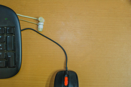 Office desk with office equipment,Keyboard and mouse, calculator, Earphone,phone and CD disk.Pencil, pen, ruler, Top view with copy spaceの写真素材