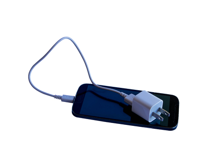 modern touch screen smartphone and Cables phone chargers isolated on white backgroundの写真素材