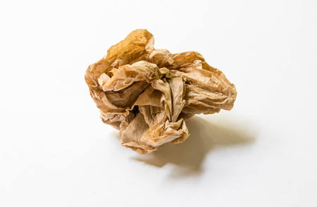 Crumpled paper ball isolated on white backgroundの写真素材