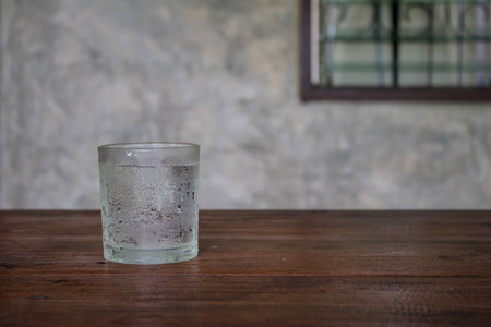 Cold water in the glass  On a wooden deskの写真素材