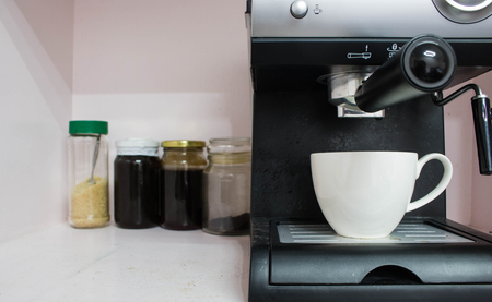 coffee cup with coffee maker on pink wooden backgroundの写真素材