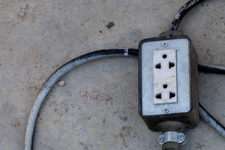 Old electric plug, Multiple socket Used in external activities on Cement floorの写真素材