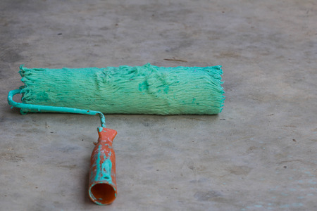old Roller paint brush on Cement floorの写真素材