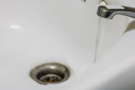 close-up  drain water from the old water tap In the bathroomの写真素材