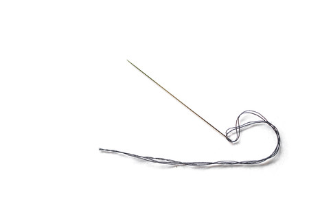 Close-up needle and a thread on white background with copy space for textの写真素材