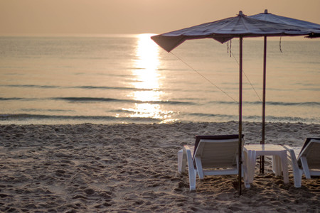 Beach chairs with umbrella and beautiful sand beach In the morning with copy spaceの写真素材