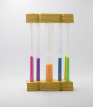 Multi color hourglass clock on white background. concept for business deadline, urgency and running...