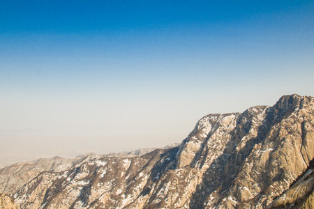 The mountains and the snow with blue sky backgroundの写真素材