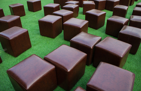 Brown Cube chair On the grass backgroundの写真素材