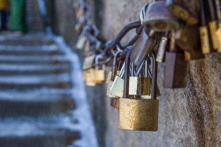 Group of locked love padlocks on rusty railing on the mountains with togetherness and love faithfulness concept.with copy spaceの写真素材