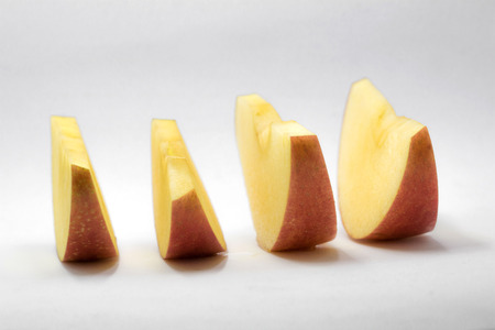 apple red knife dissect on white backgroundの写真素材