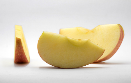 Close-up apple red knife dissect on white backgroundの写真素材