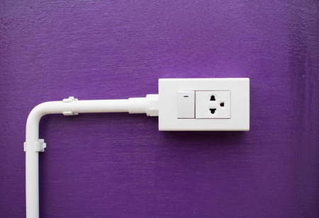 Close-up White Switch And  Plug on Purple wall with copy spaceの写真素材