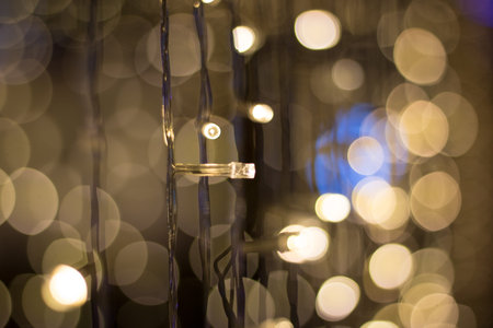 Close-up Soft yellow Mini lamp with blurred electric branches of lamp on dark background