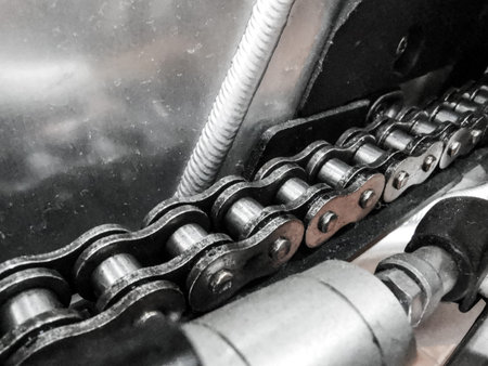 Close up of a dirty motorcycle chain with copy space