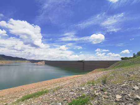 The area behind the dam With lots of water and blue sky with cloud background